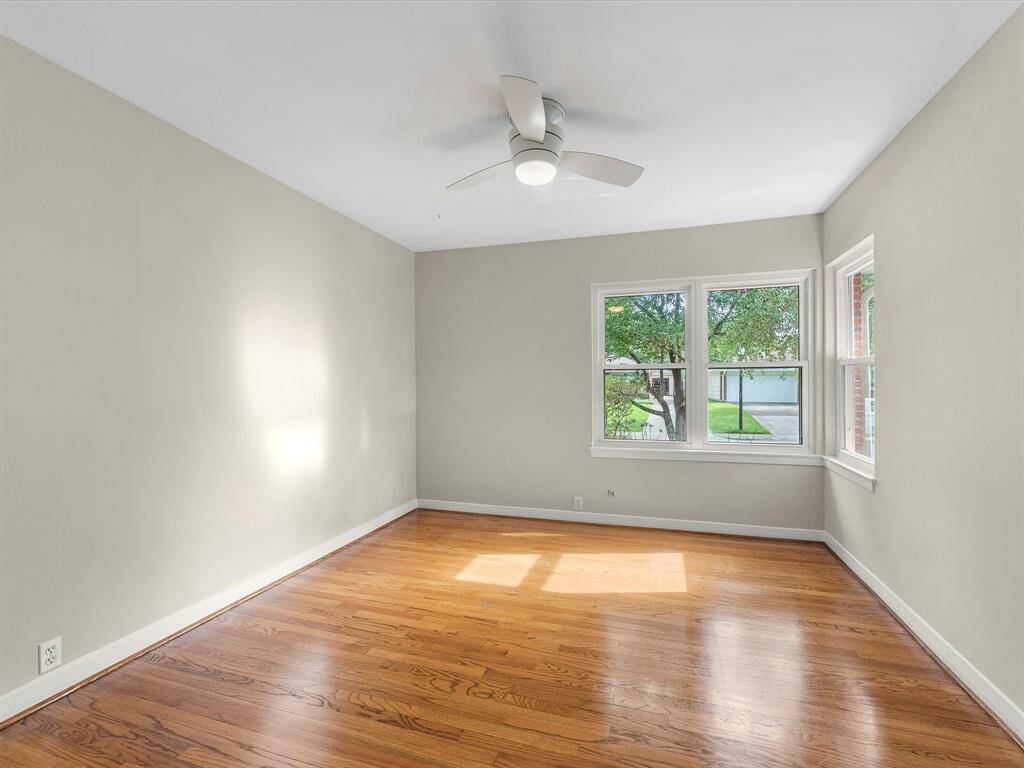 Bright and inviting front bedroom with large windows and ample natural light.