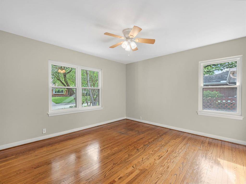 Bright and airy bedroom with hardwood floors and ample natural light.