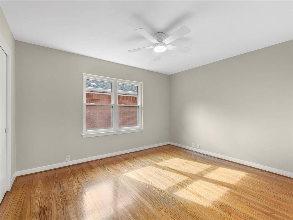 Bright and inviting third bedroom featuring stunning hardwood floors.
