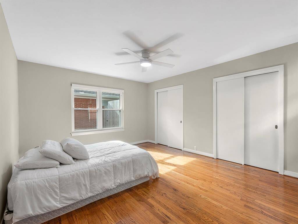 Spacious primary bedroom featuring dual closets for ample storage. Virtually Staged