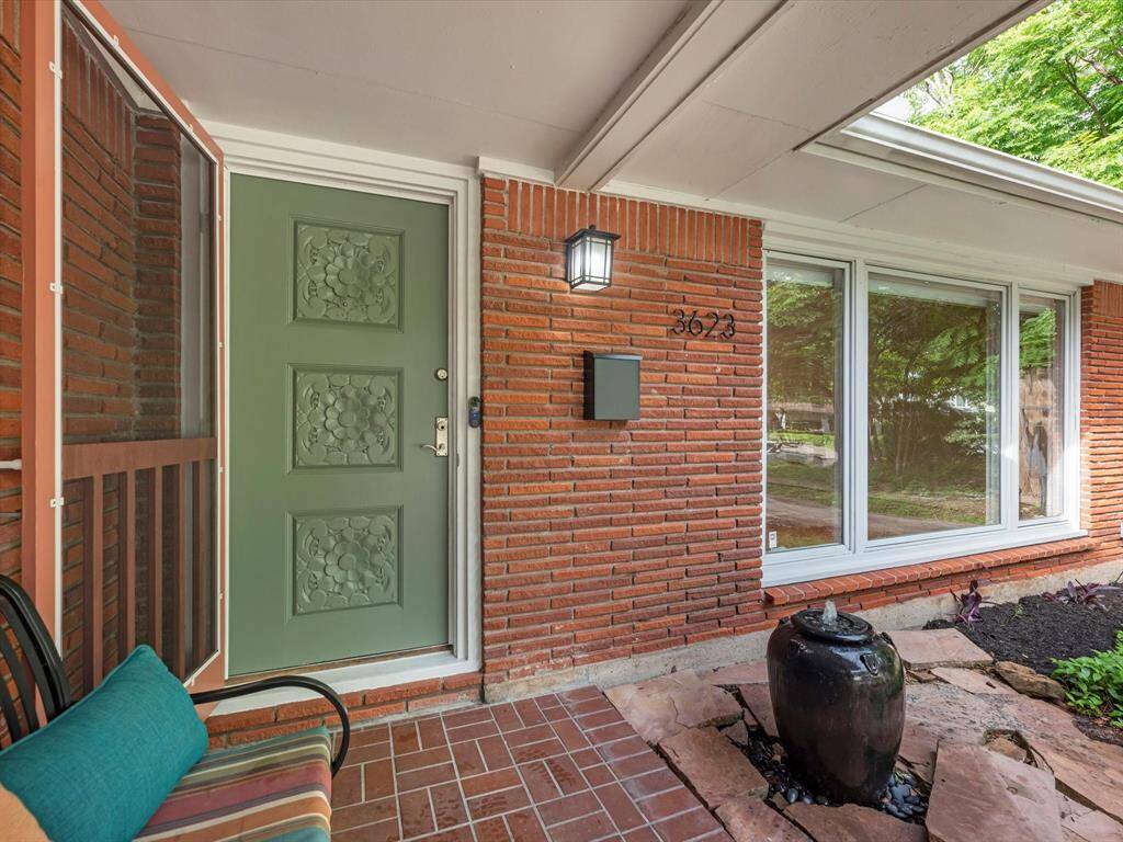 Enjoy the fresh breeze with a charming screen door, perfect for cool weather days.