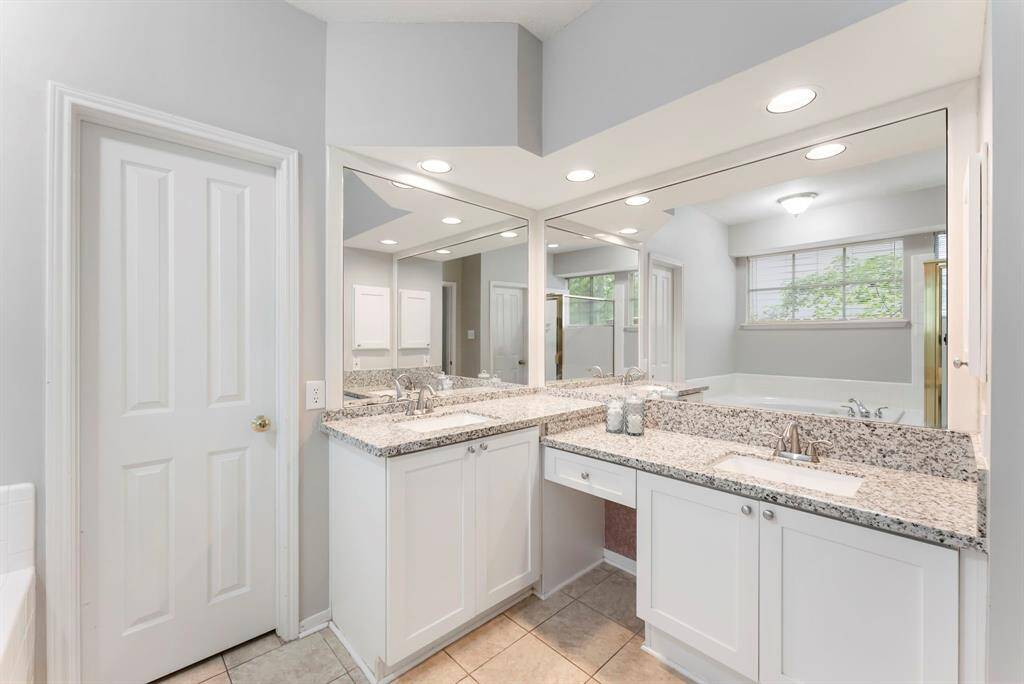 The primary bathroom is equipped with double sinks, soak-in tub and separate shower.