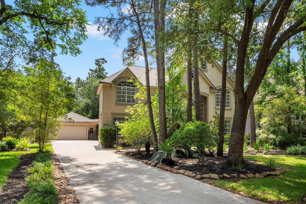 A long and spacious driveway leads to the detached garage.
