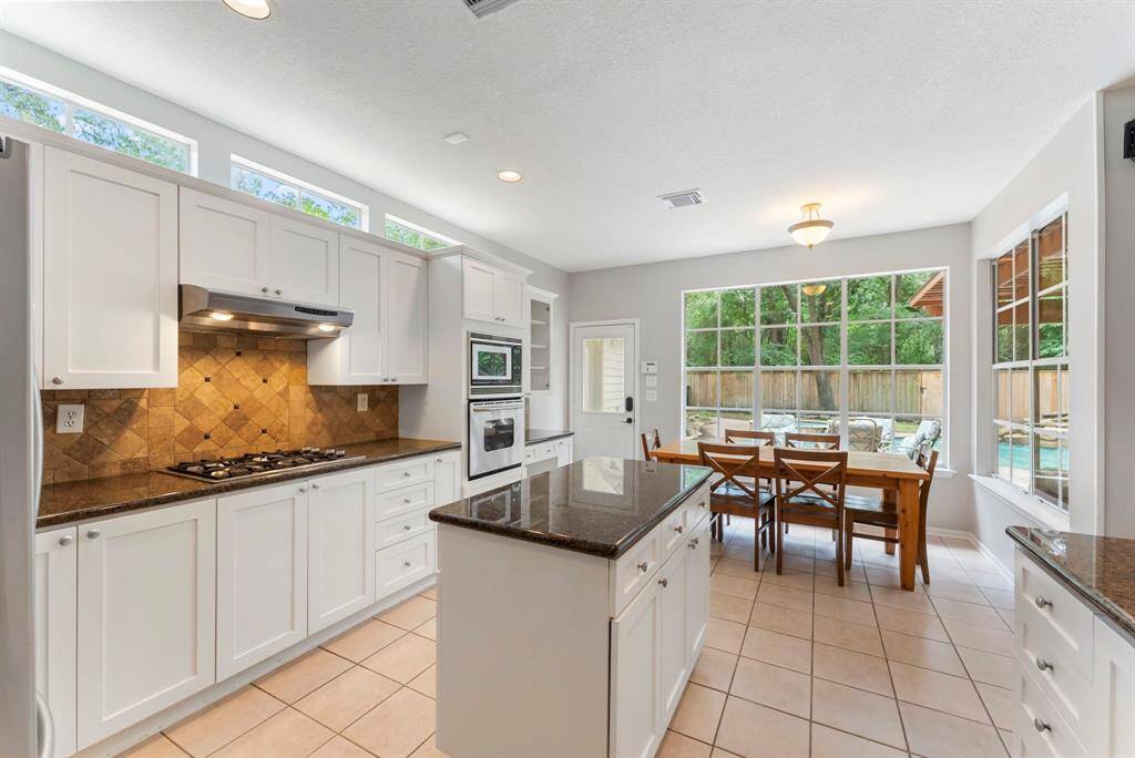 The kitchen showcases an island, and ample cabinet and counter space.