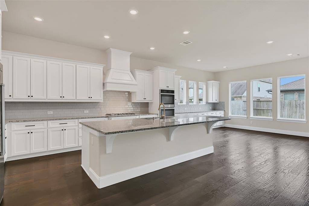 Overall Kitchen Layout and Breakfast Room Perspective! Chefs aren't Tucked Away and Excluded from the Fun in This Massive Space!