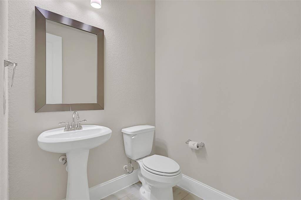 Downstairs Powder Room is Discreetly Located Down the Hallway for Additional Privacy! Even This Bathroom is Spacious!