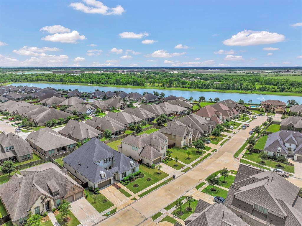 The Home with the Dark Grey Roof is the Subject Property and this Prospective Highlights the Short, Strollable Distance to the Nearby Community Lake. Also Close by and Walkable is Both a Daycare and Elementary School.