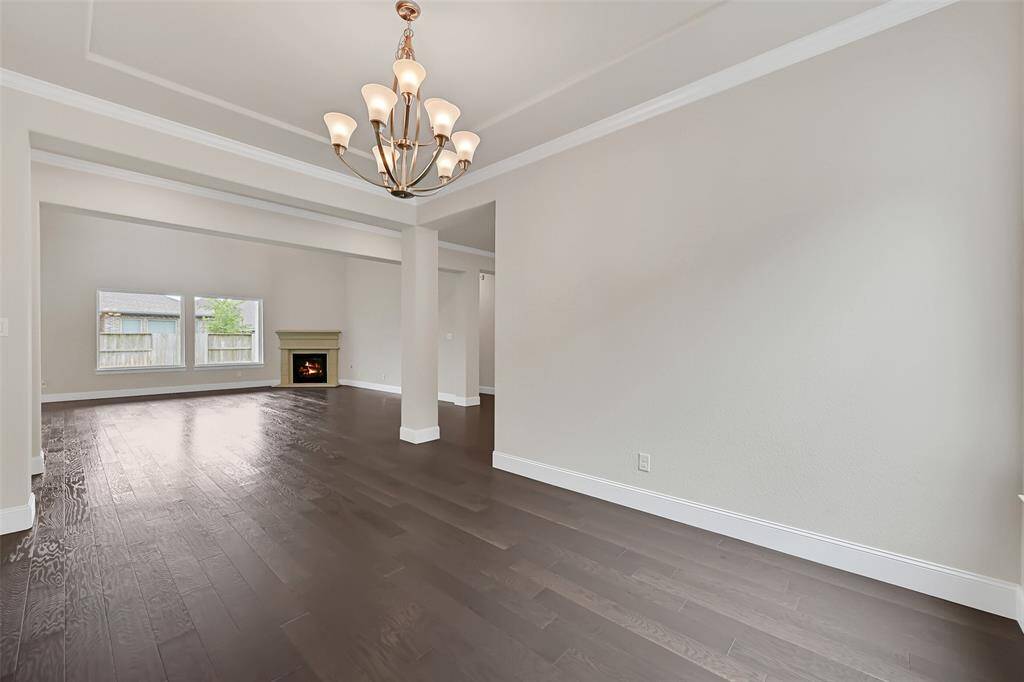 A View from the Formal Dining Room, Looking Through the Living Room and Towards the Fireplace! Nice Lighting, Crown Molding and Recessed, Tray Ceiling Design!
