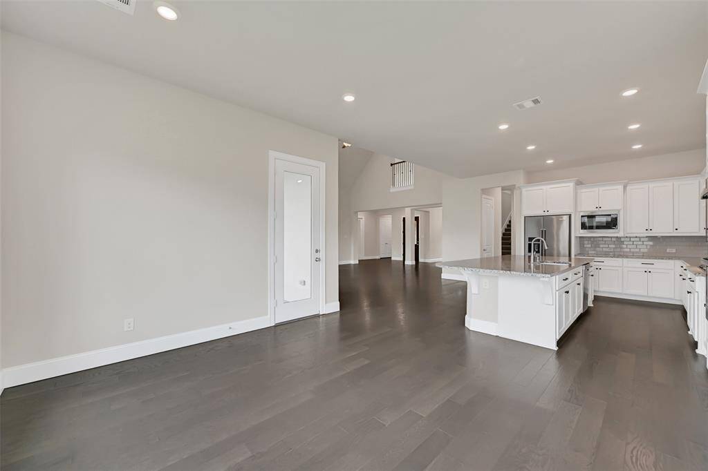 Looking from the Breakfast Room Area, This is the Sightline to the Front Entryway! The Door to the Left Provides Access to the Large Covered Porch, Designed for Outdoor Living or an Outdoor Kitchen Area - Your Choice!