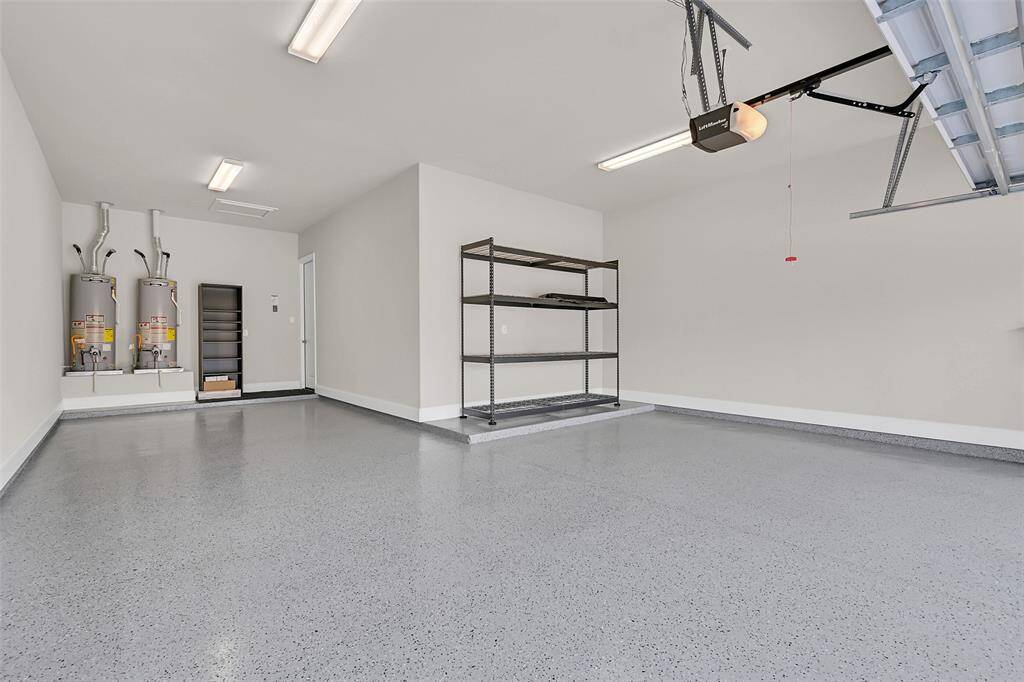This Massive Garage holds Three Vehicles or, if You Prefer, Lots of Space for a Workshop Area and Two Cars! Epoxy Coating with Sealer Helps to Keep the Garage Floor so Clean, it Makes a Nice Play Area for the Children on Rainy Days!