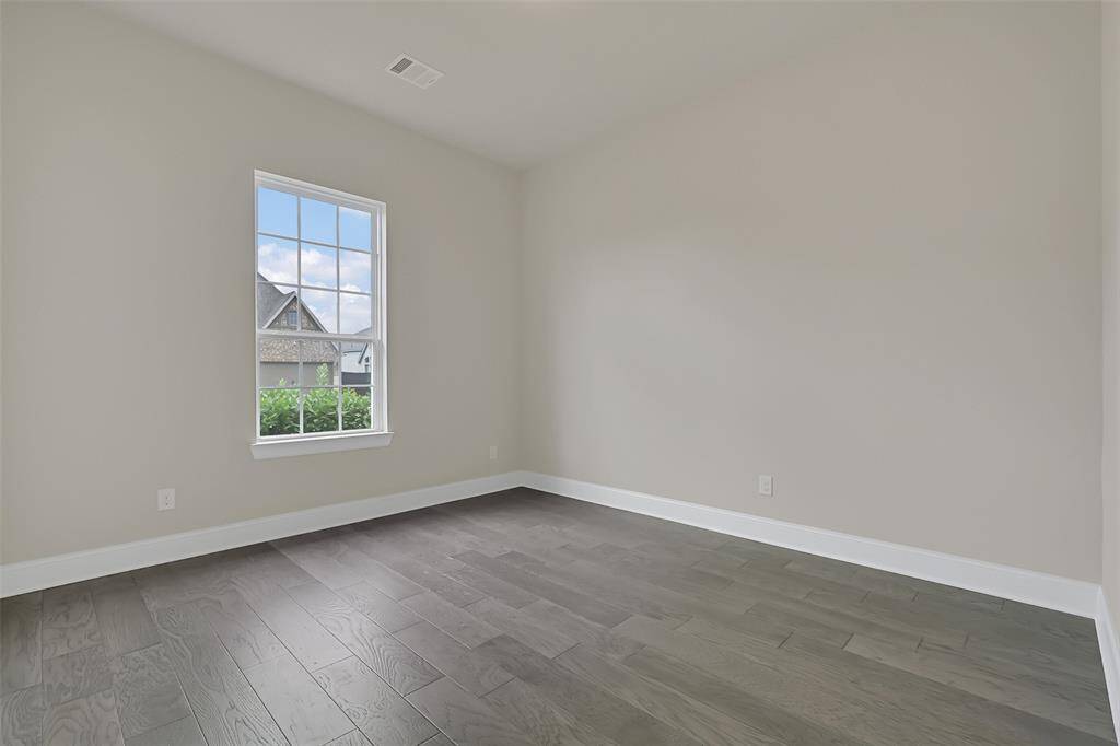 This Guest Bedroom is Located at the Front of the Home, Has Its Own En-Suite Full Bath and Could Serve as a Smaller Primary Bedroom. This Room Would be Perfect for an Extended Family Member, Nanny or Guest Bedroom Wanting the Privacy of Their Own Bathroom. Located Near Two Other Bedrooms and Away from the Larger Primary Suite!
