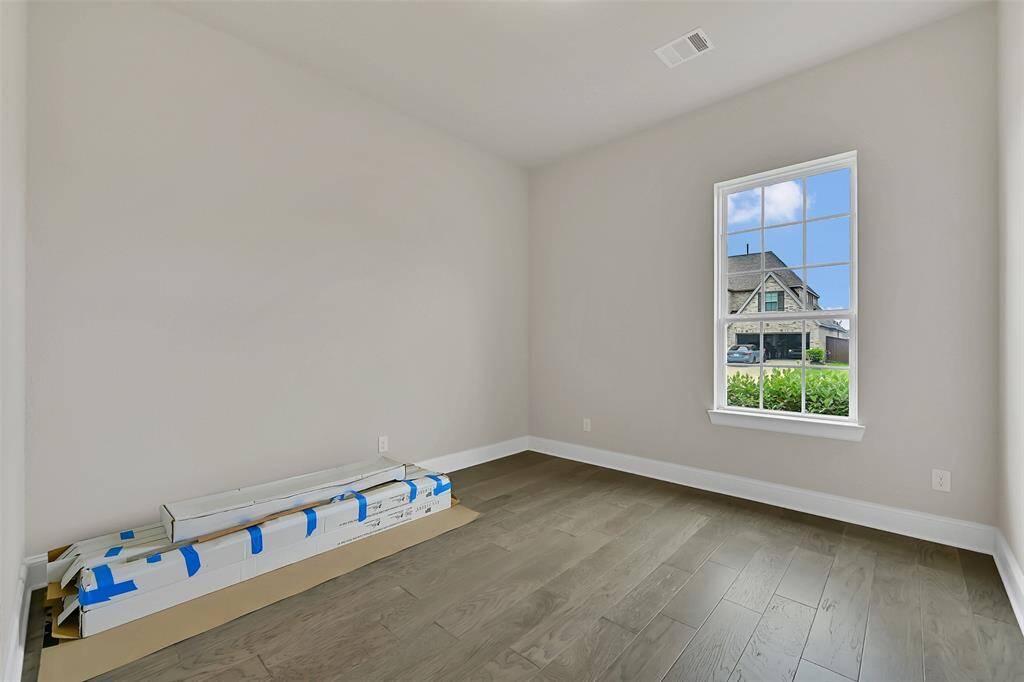 This is One of Two Bedrooms That Share a Hollywood Bath and is Located at the Front of the Home.  Note the Engineered Wood Flooring Throughout This Home! Although This Type of Flooring is Pretty Indestructible, Shown Here is Additional Matching Flooring - Just In Case!