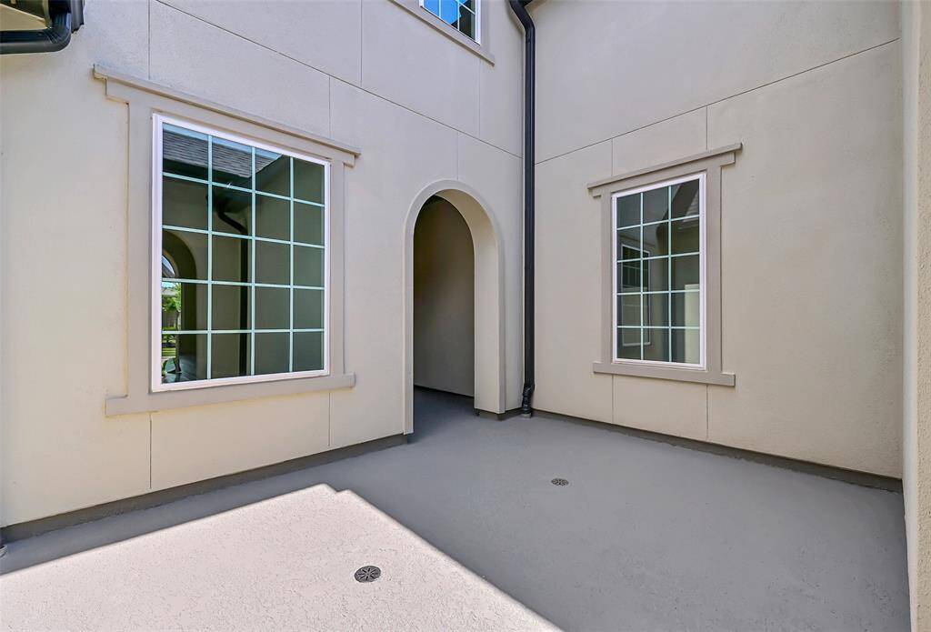 Once Inside the Private Courtyard Area, You May Proceed to the Front Door Through Yet Another Grand Arch with the Entry, Protected from the Weather! Copious Drainage and Gutters Ensure No Rain Events on Your Parade!