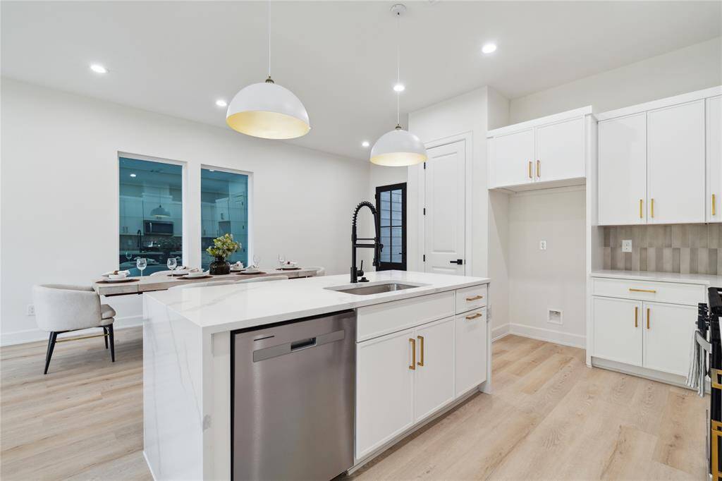 Enjoy extra cabinet space on the oversized island, perfectly positioned to overlook the living area. This charming and functional addition makes entertaining and everyday living seamless.