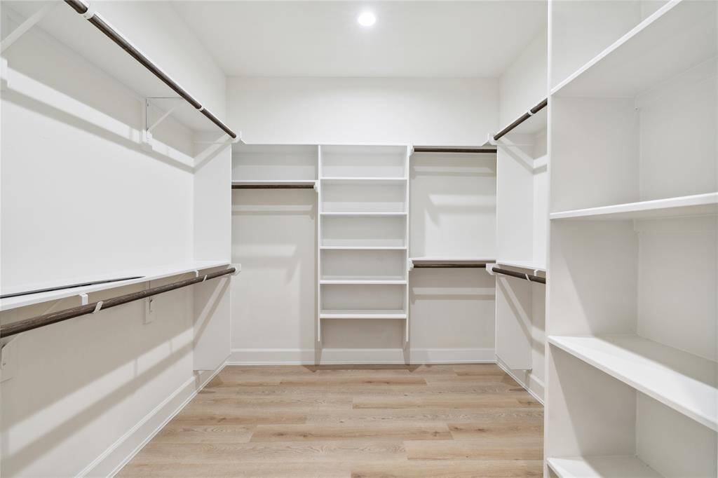 An oversized walk-in closet with shelves, offering ample storage space for your wardrobe essentials. Perfectly designed to enhance organization and convenience in your daily routine.