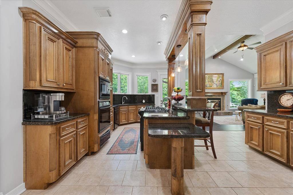 Tons of custom cabinetry, window overlooking back patio and yard. Can see horses from your kitchen window!