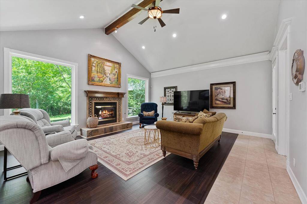 Vaulted ceiling in family room with huge picture windows! This home has extensive custom trim and molding that was all done on site!
