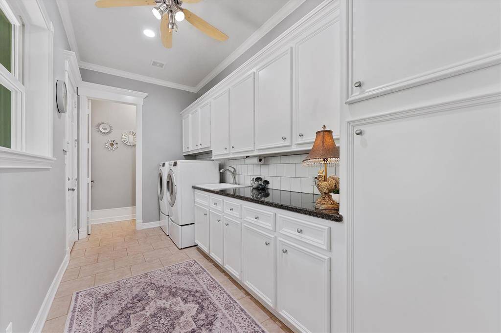 Oversized laundry room with 2nd half bath and full size sink for clean up when coming in from garage or to outside!