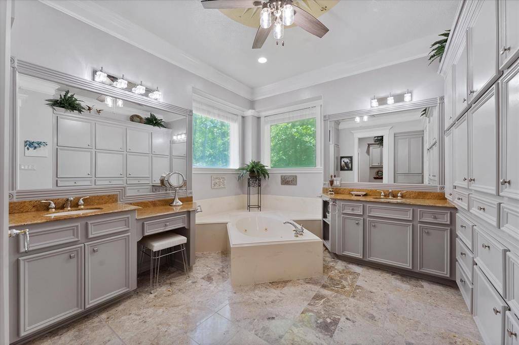 Primary bathroom with TONS of custom cabinetry for storage!