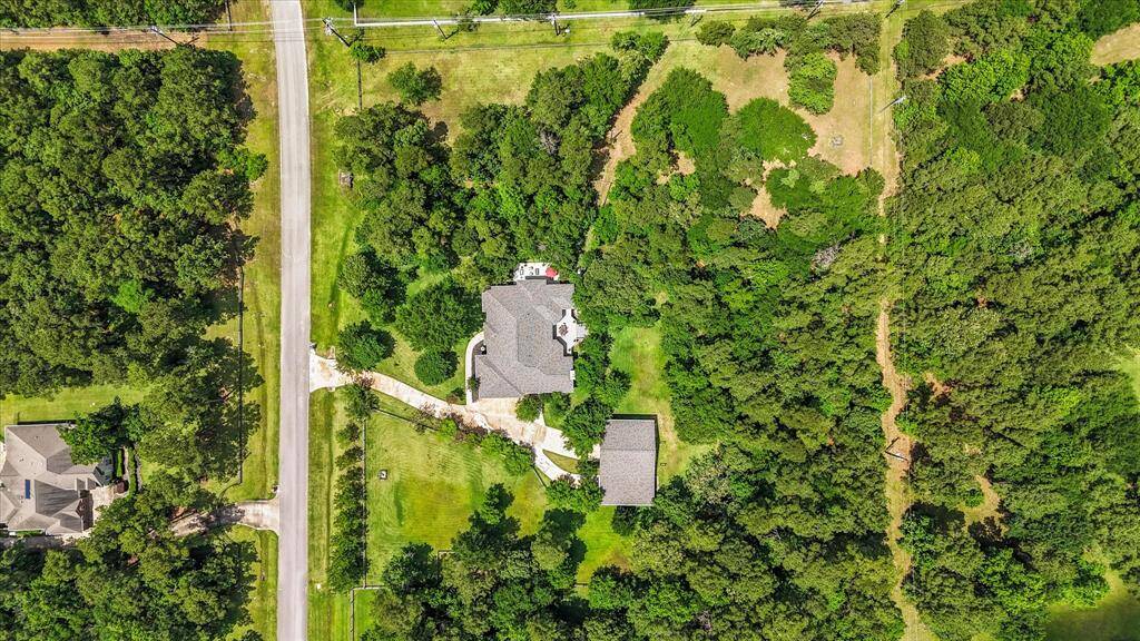 Aerial view of this gorgeous home! Very versatile floorplan! Enter in on the main floor from garage to main living ares and primary bedroom plus 2 more bedrooms or extra bedroom and study! Walk out basement has kitchenettte, gameroom, 3 more bedrooms with huge closets plus another office area!