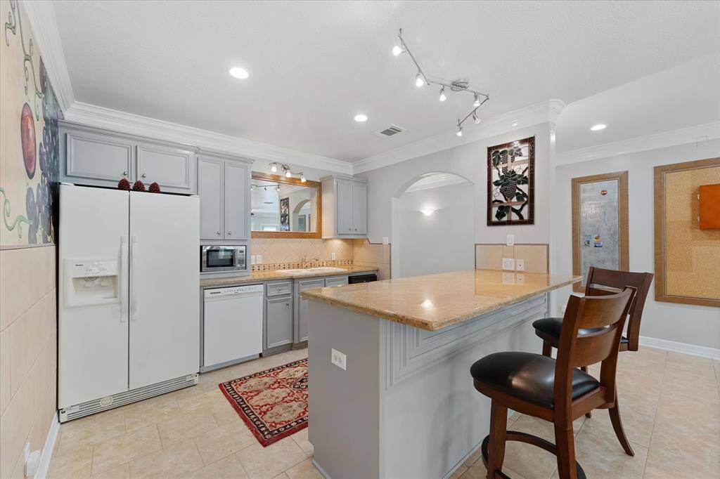 Kitchenette has full sized sink, dishwasher  and microwave. Area for full size refrigerator and wine /beer frig