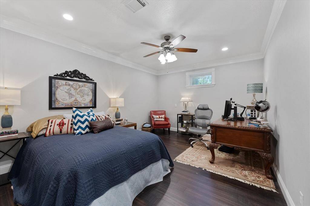 Secondary bedroom in walk out basement which owner uses as another office