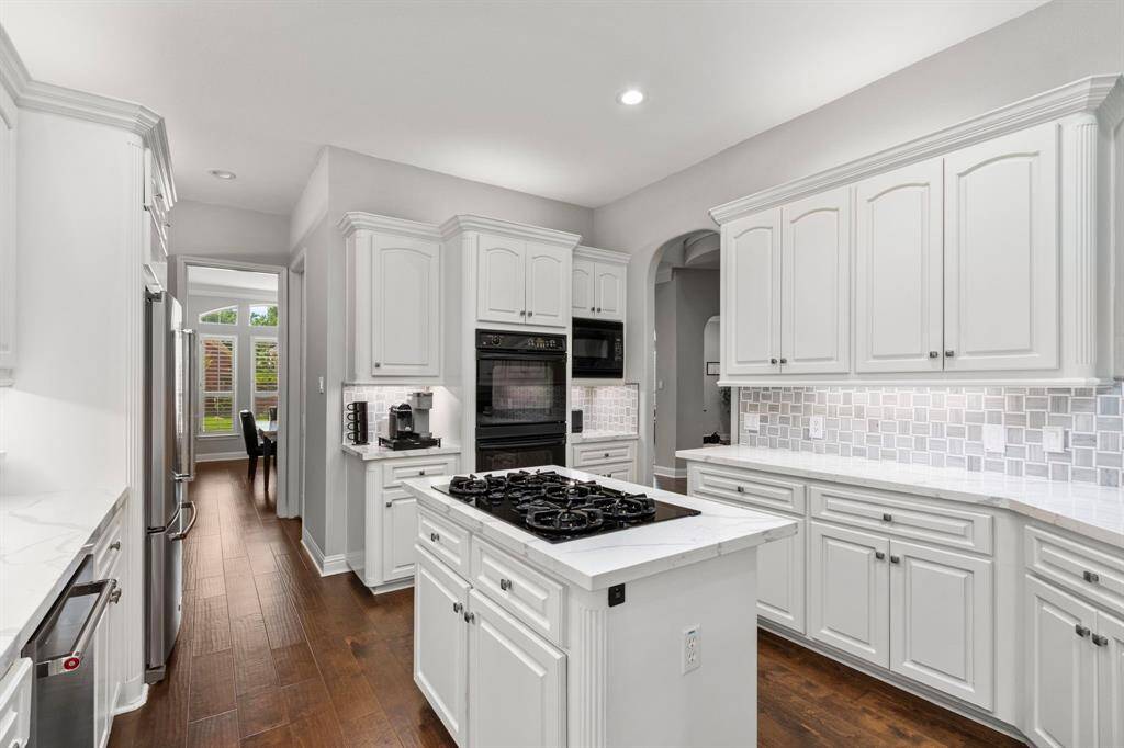 The kitchen appliances include a GE Profile gas burner cooktop, built-in double ovens, microwave, dishwasher and undercounter wine fridge.  The Kitchen Aid refrigerator stays with the house.
