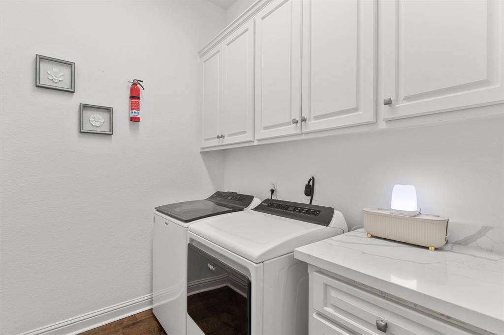 The laundry room has great cabinet storage and the Whirlpool washer and dryer stay with the house.
