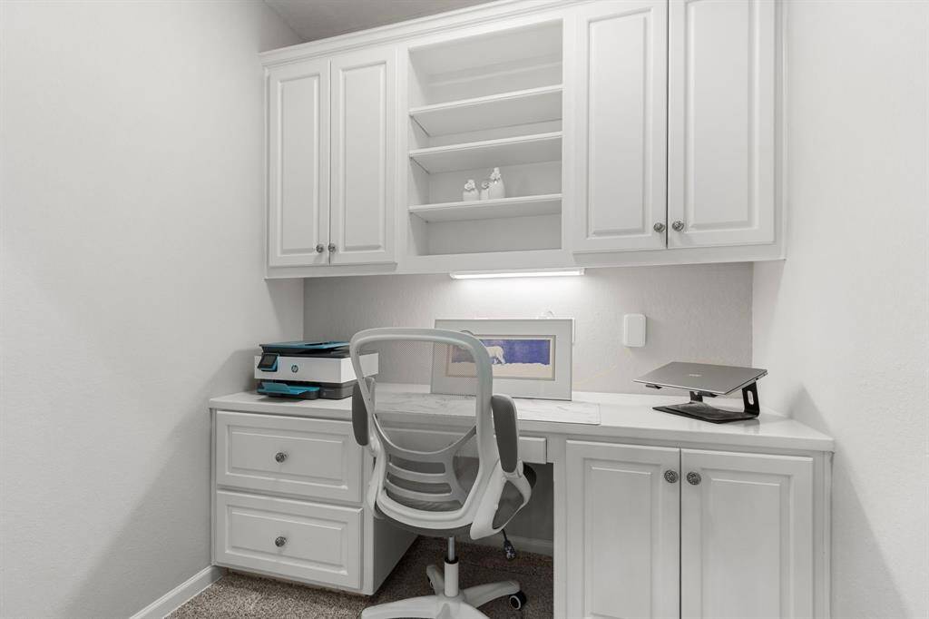 This convenient study nook with built-ins is located on the second floor landing between the secondary bedrooms and gameroom.