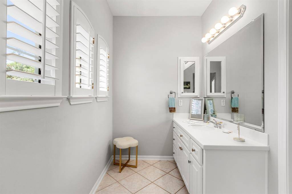 The other side of the shared Jack-and-Jill bath. Both sides offer nice-sized vanities with plenty of undercounter storage and expansive mirrors.