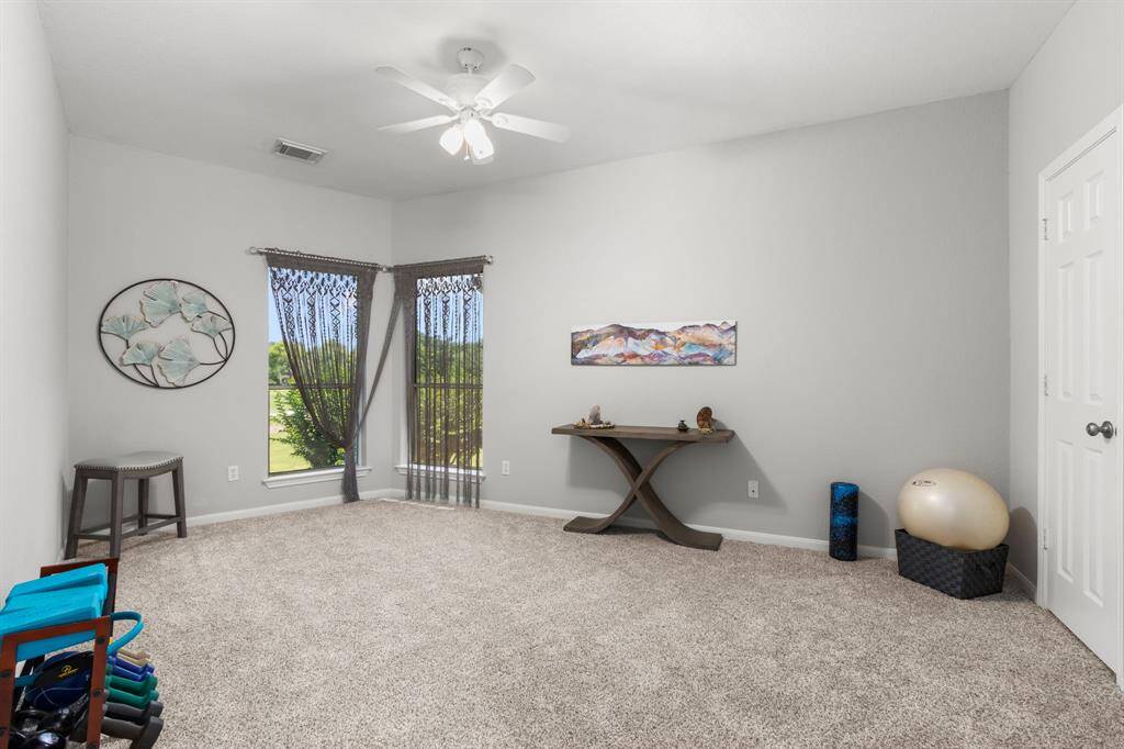 This spacious secondary bedroom with nice-sized closet is currently being used as a yoga room. It has a private bath that has a separate door that opens to the hallway for the gameroom.