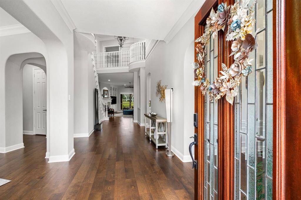 Upon entering you are greeted with a light and bright entry with high ceilings, handsome engineered hardwoods and beautiful design features.