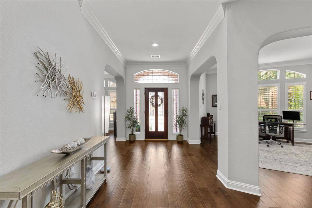 A look back from the entry hallway to the front door and through archways on the right to the study and a peak on the left into the formal dining room.