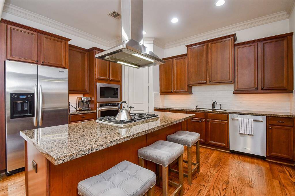 Large island with places to have barstools for entertaining. Look at all the storage!