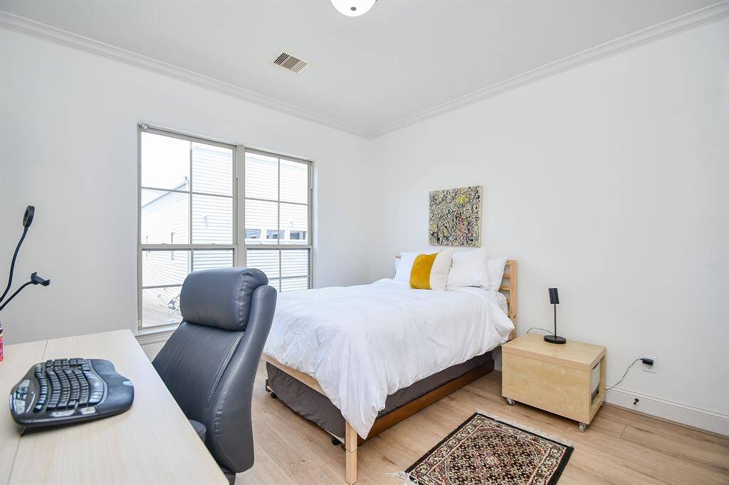 Spacious secondary bedroom on 3rd floor. This room has a custom walk in closet and full bath.
