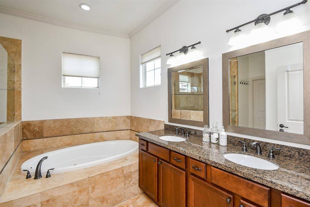 Primary bathroom with jetted tub with double sinks.