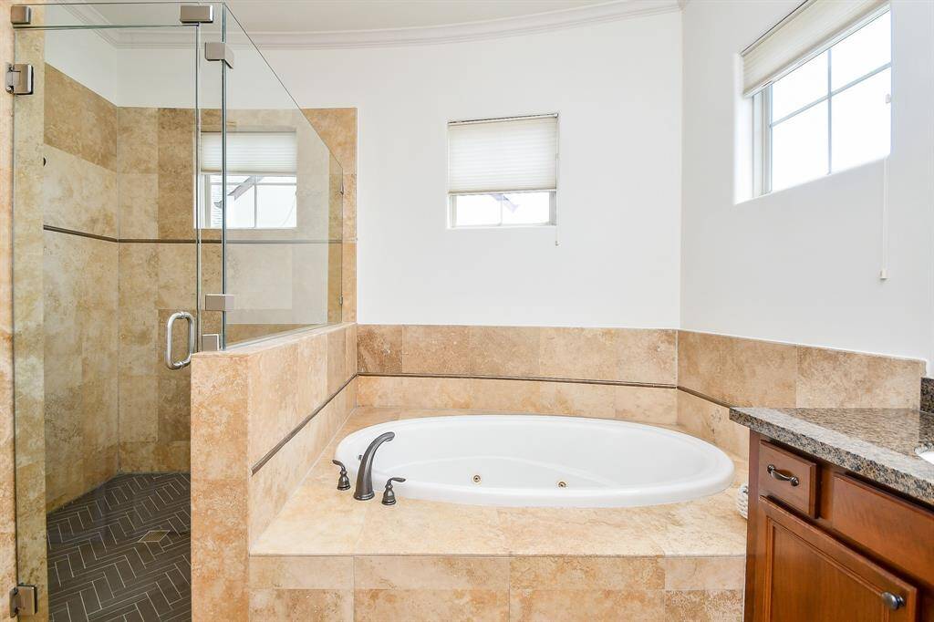 Jetted tub and shower in primary bathroom on 3rd floor.