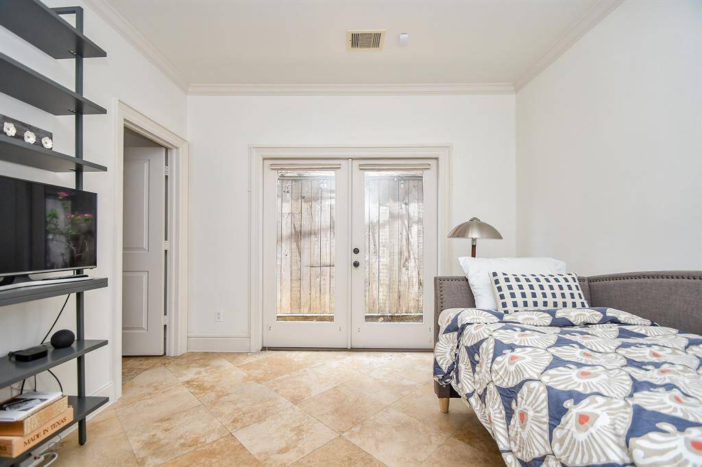 First floor ensuite bedroom with patio access and full bath.