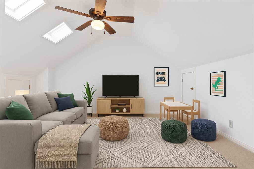 The inviting game room is filled with natural light from overhead skylights, creating a bright and airy atmosphere. Built-ins and a media niche provide the perfect setup for entertainment and relaxation.