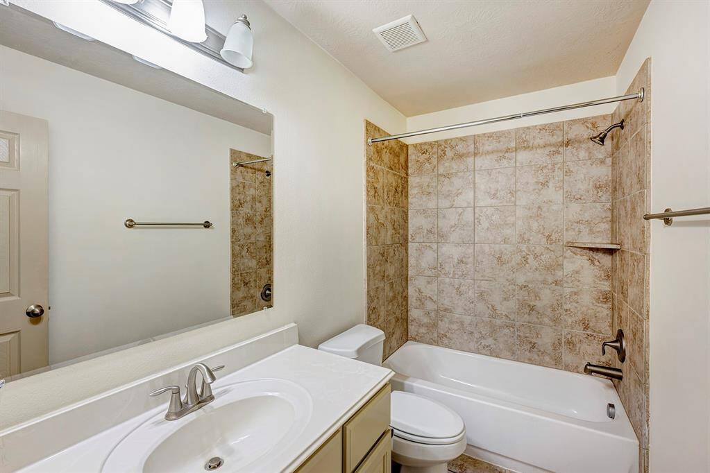 The primary bathroom esigned for convenience and comfort, featuring a double-sink vanity with granite countertops. The dual sinks provide ample space for two people to use simultaneously, making the morning routine more efficient and organized. Each sink has its own polished nickel faucet, under-mount basin, and wall-mounted mirror, allowing for a personalized grooming area.