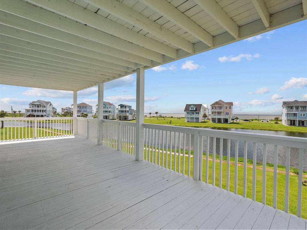 Second floor covered deck walk out from two bedrooms offers the perfect spot to enjoy ocean breezes
