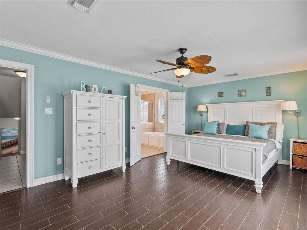 Second Floor:Wake up to breathtaking water views in this luxurious coastal primary bedroom.