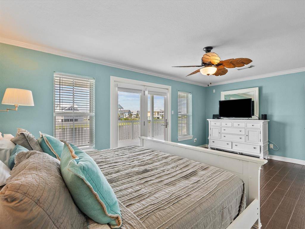 Primary bedroom with doors to spacious balcony.