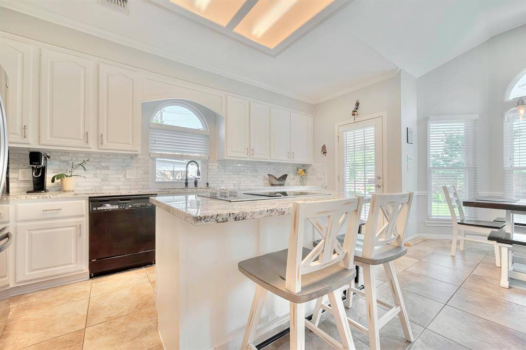 A view of the beautiful kitchen with granite countertops and working island.