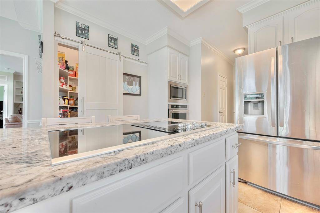 The kitchen island features an electric cooktop