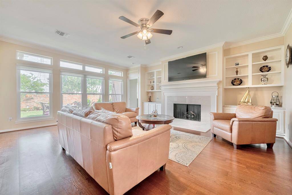 This spacious living space features plenty of natural light and a cozy fireplace