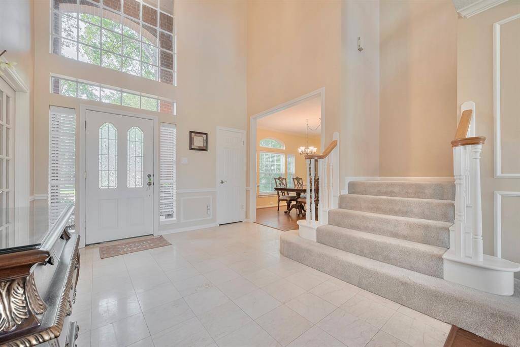 The foyer to the home features high ceilings.
