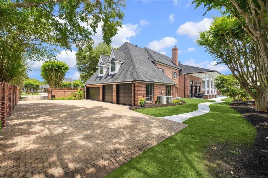 4 car attached garage with extra parking. Privacy brick fence.