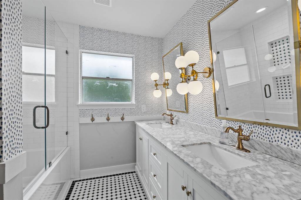 Second Level Guest Bathroom featuring new vanity, countertop, tiles, tub, shower surround, glass shower, lighting and hardware