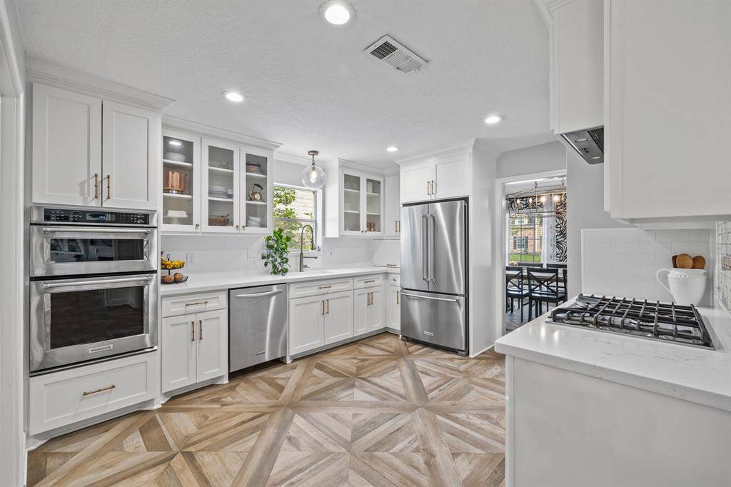 Kitchen- featuring new cabinetry, hardware, quartz countertops, stainless appliances and gas stove